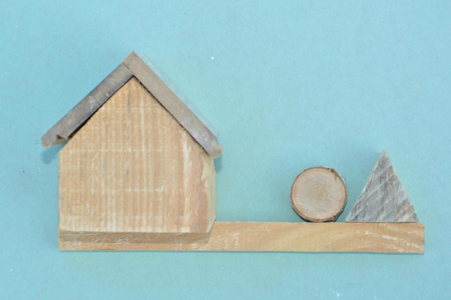 Wooden model of a house and family photo