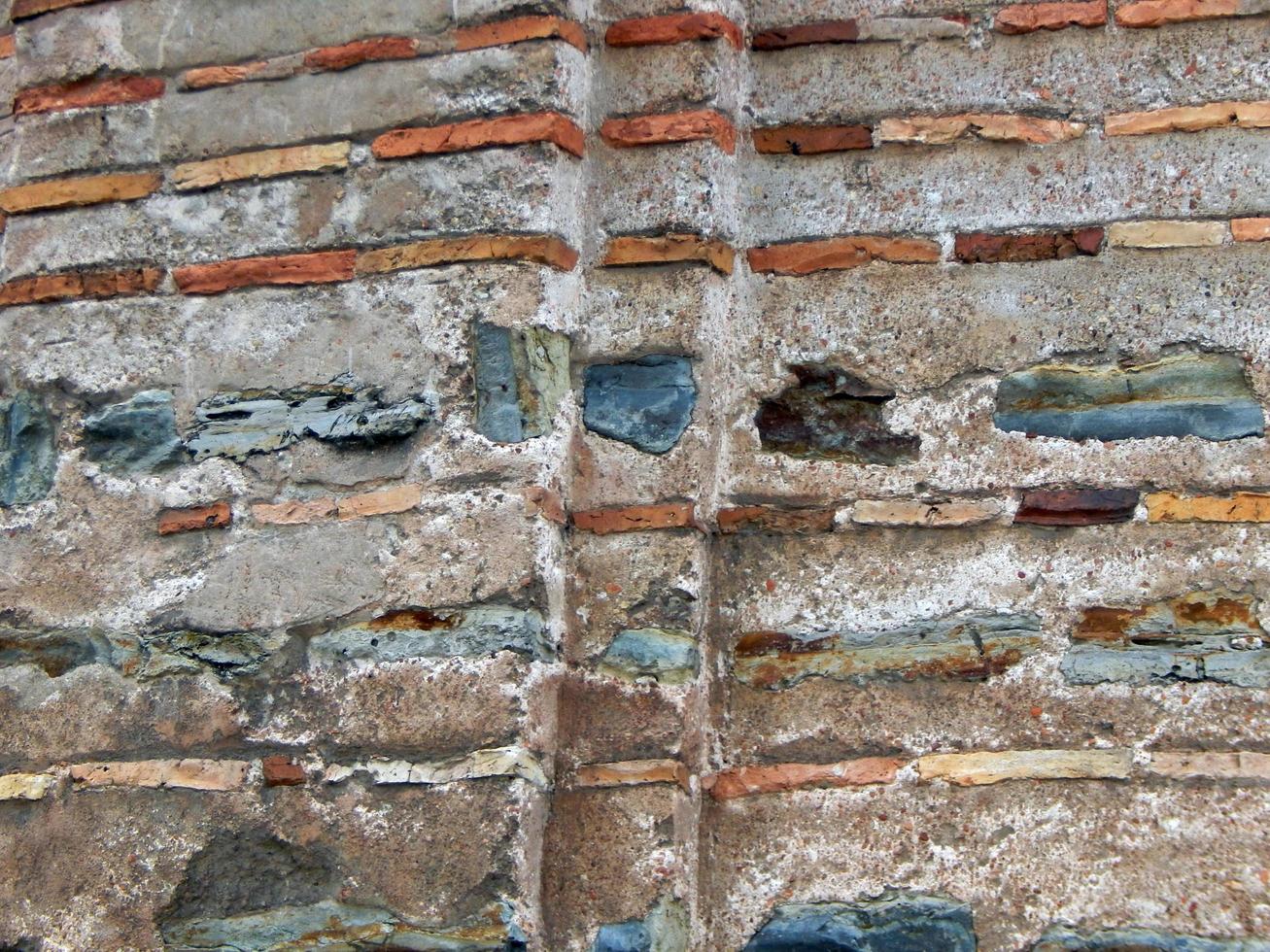 Texture of natural stone material and brick masonry walls photo