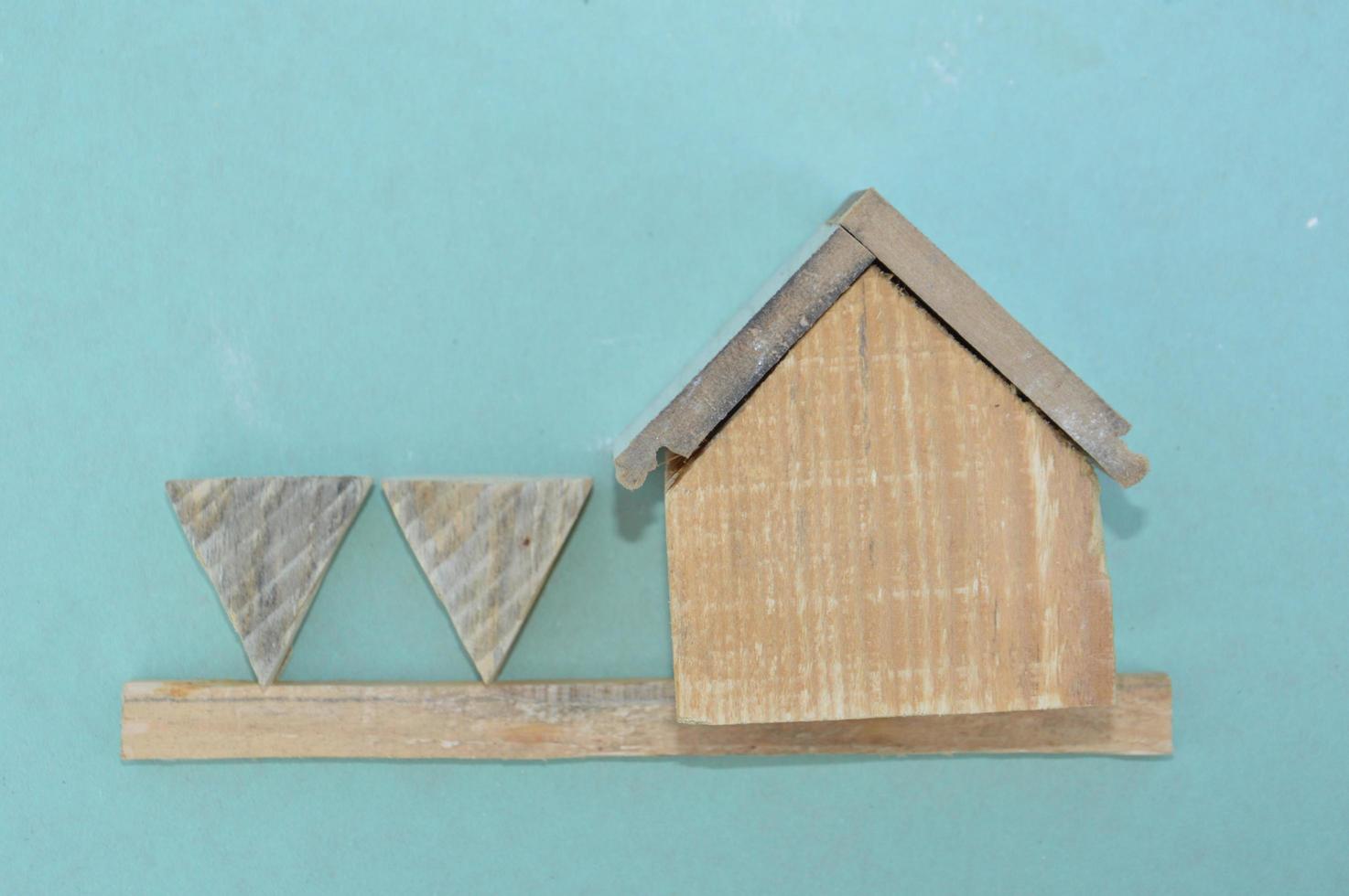 Wooden model of a house and family photo