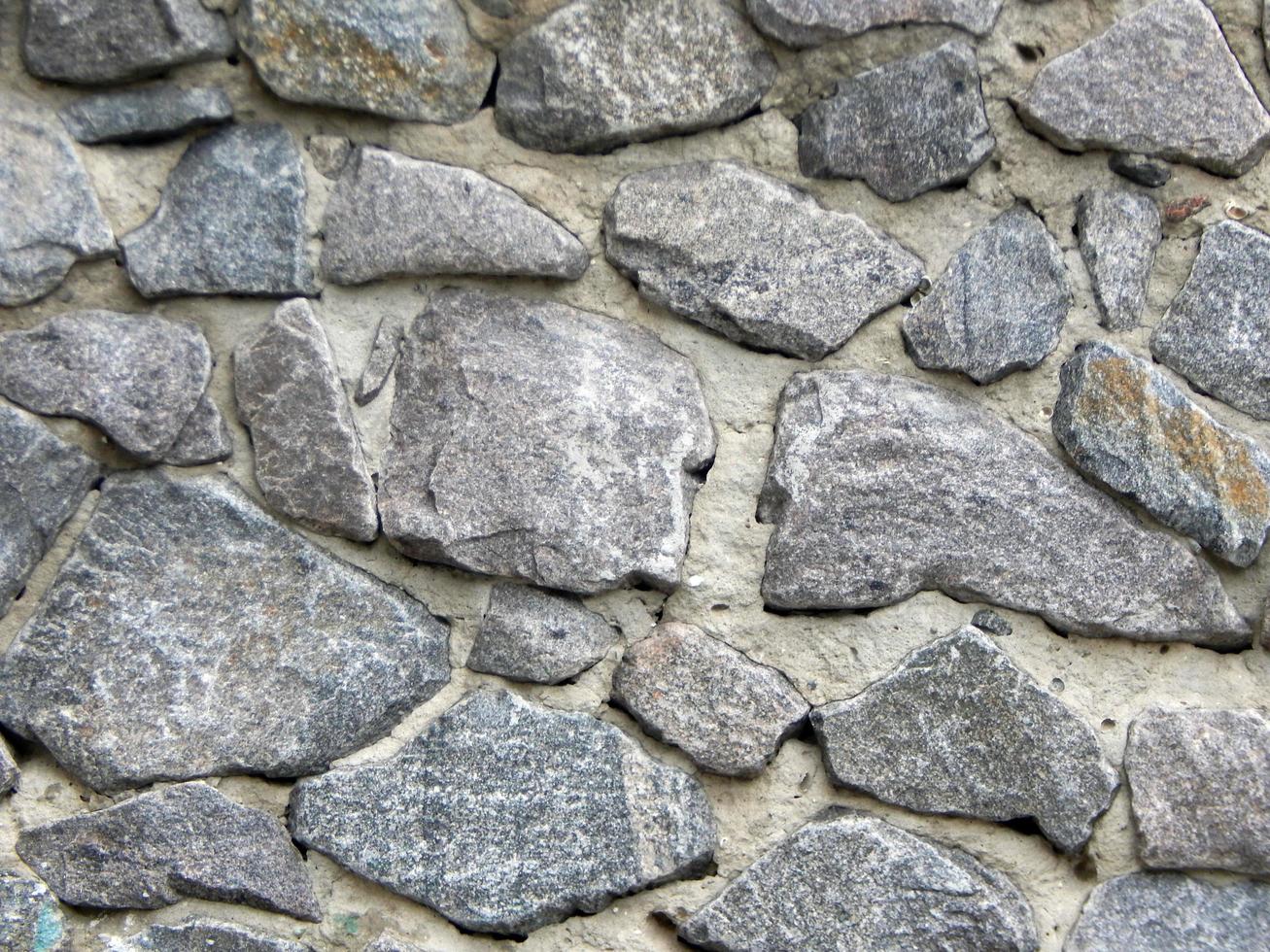 Texture of natural stone material and brick masonry walls photo