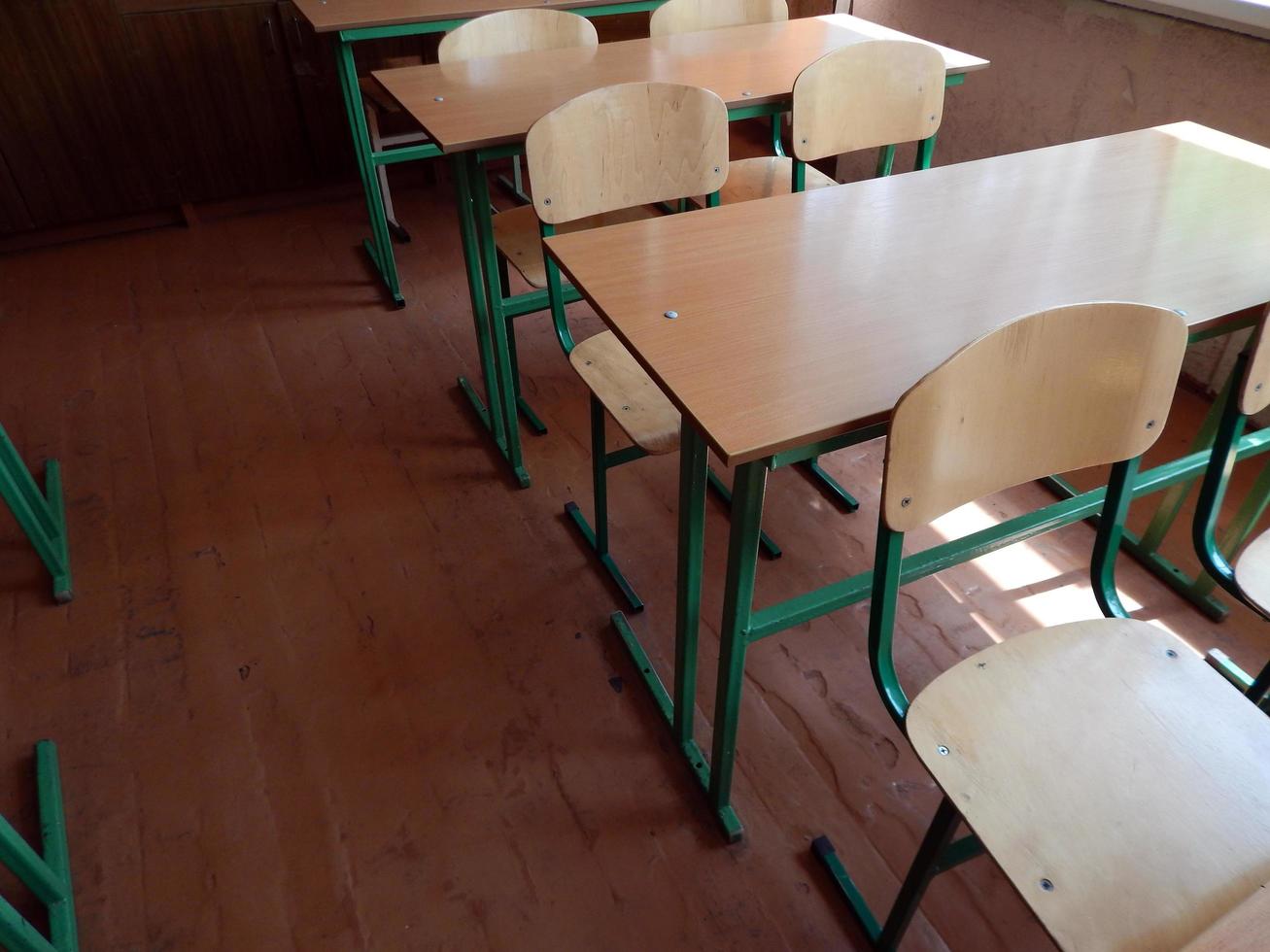 School desks in the classroom and chairs photo