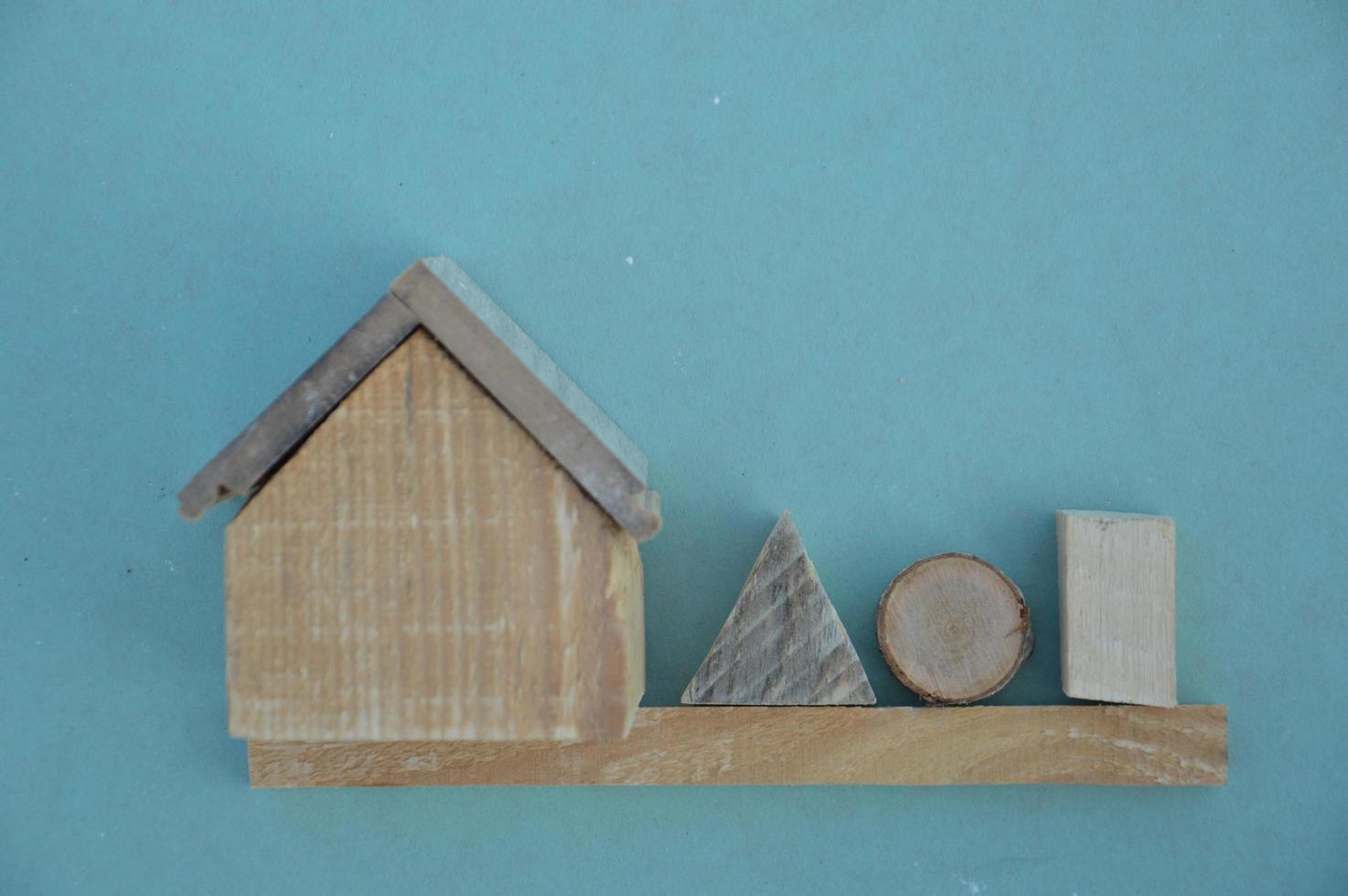 Wooden model of a house and family photo