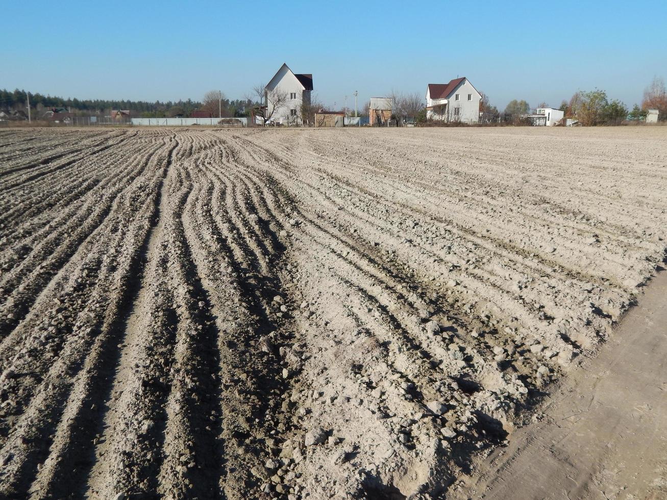Tractor plowed field and arable land photo