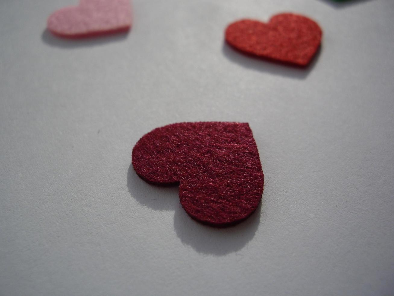 Multicolored heart shapes on a light background photo