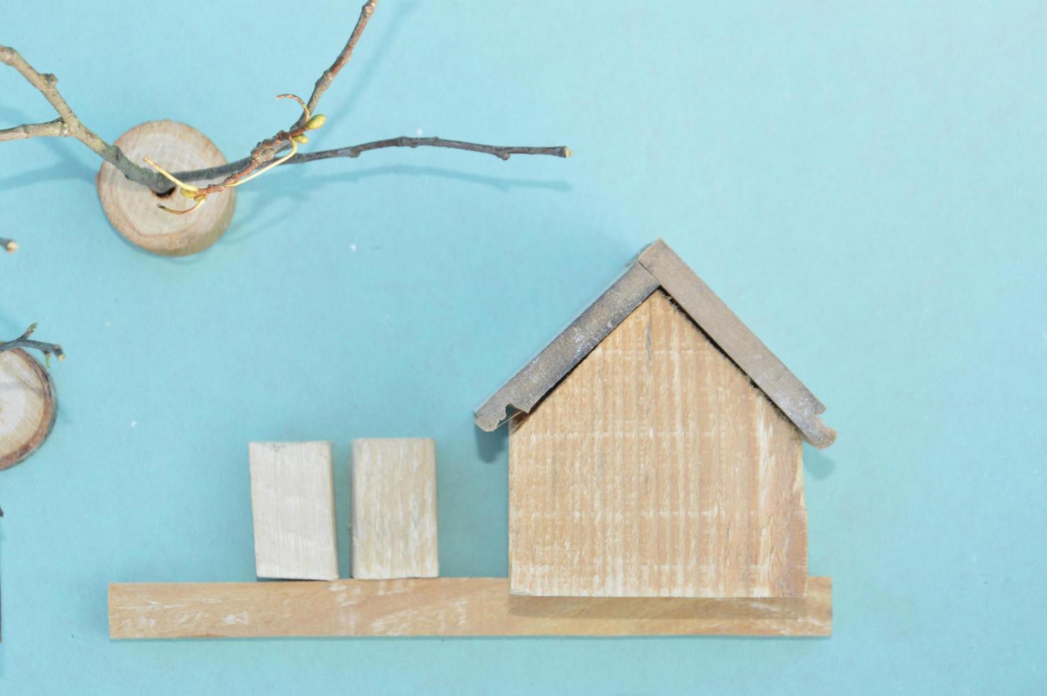 Wooden model of a house and family photo