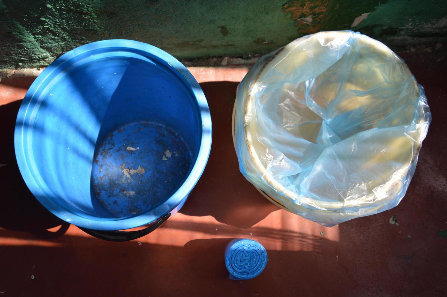 There are trash cans with bags for throwing garbage into a container photo