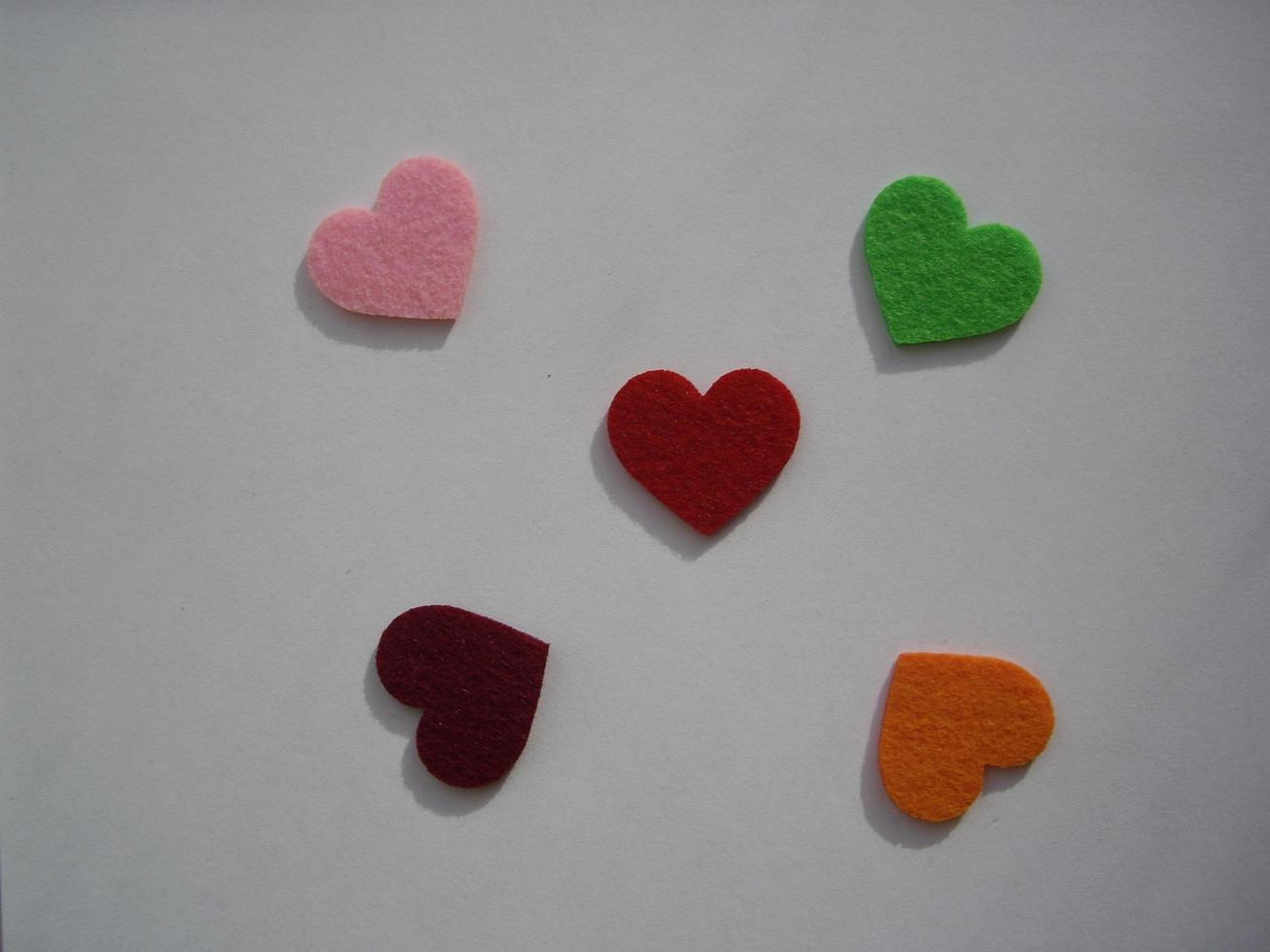 Multicolored heart shapes on a light background photo