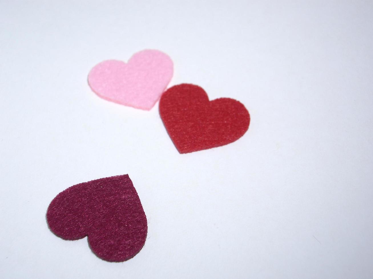 Multicolored heart shapes on a light background photo