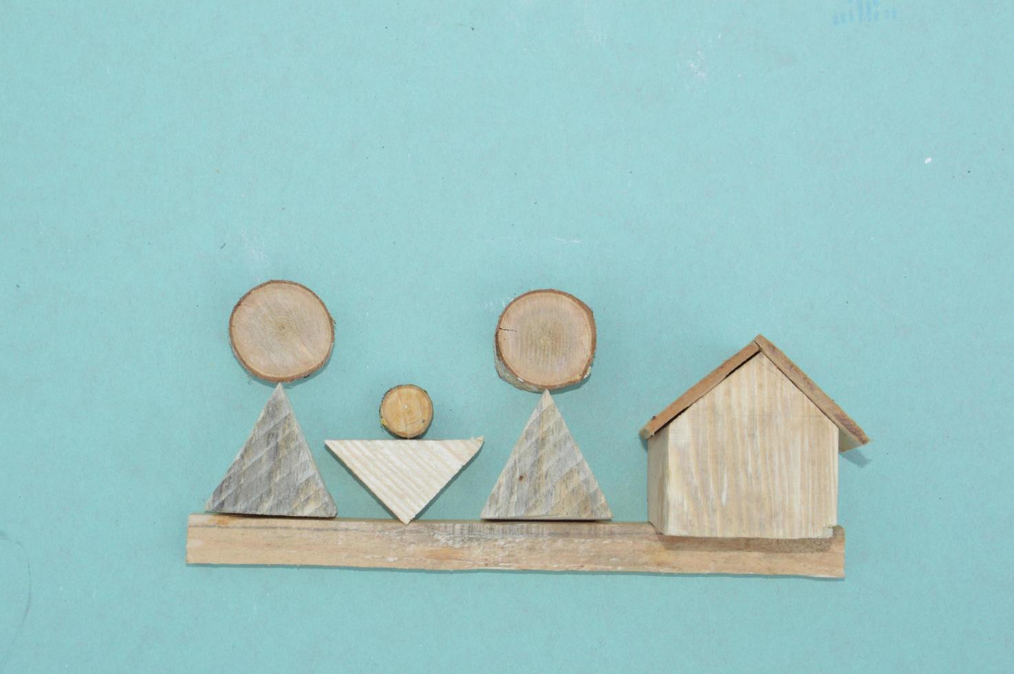 Wooden model of a house and family photo