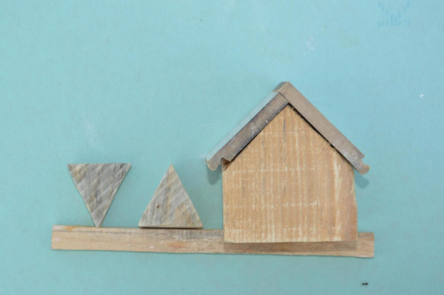 Wooden model of a house and family photo