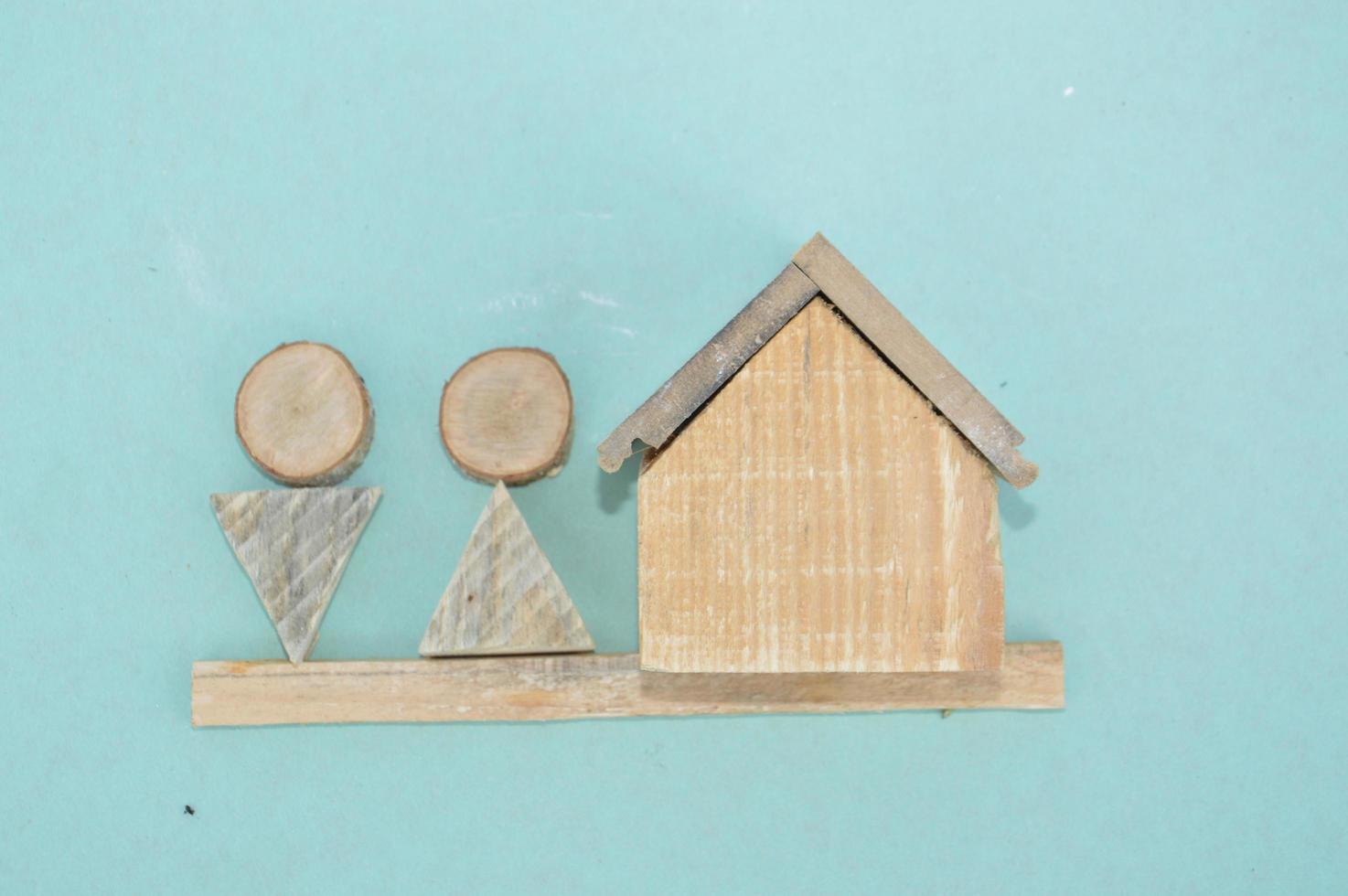 Wooden model of a house and family photo