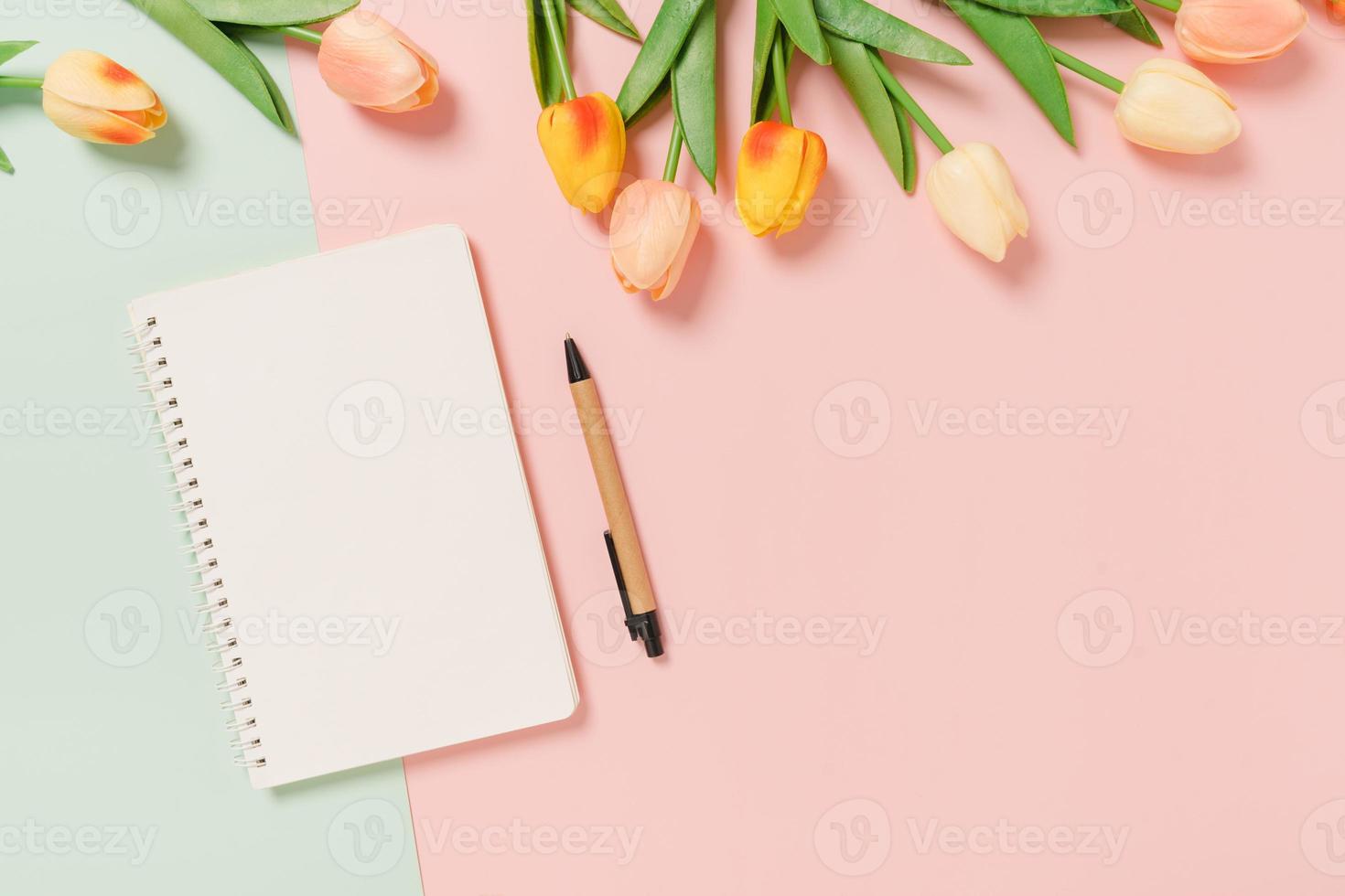 Creative flat lay of travel vacation spring or summer tropical fashion. Top view beach accessories open mockup black notebook for text on pastel background. Top view mock up copy space photography. photo