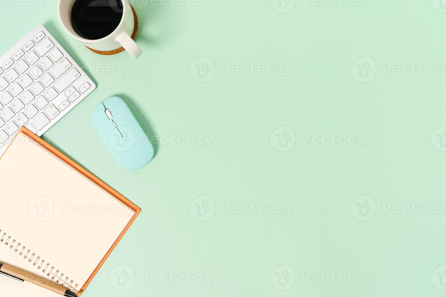 Creative flat lay photo of workspace desk. Top view office desk with keyboard, mouse and open mockup black notebook on pastel green color background. Top view mock up with copy space photography.