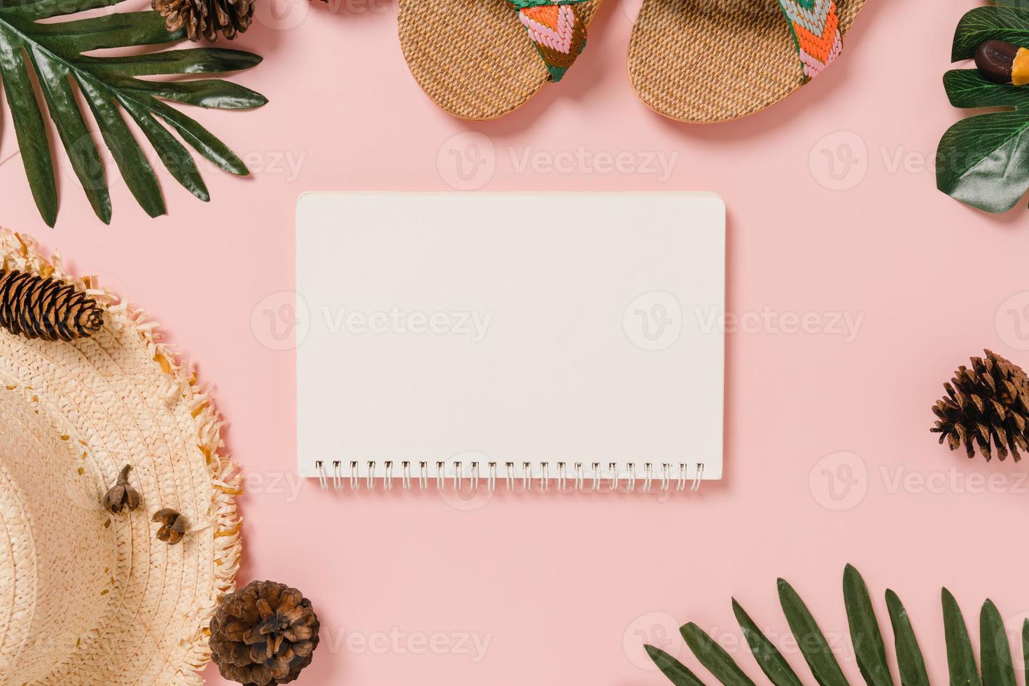 Creative flat lay of travel vacation spring or summer tropical fashion. Top view beach accessories open mockup black notebook for text on pastel background. Top view mock up copy space photography. photo