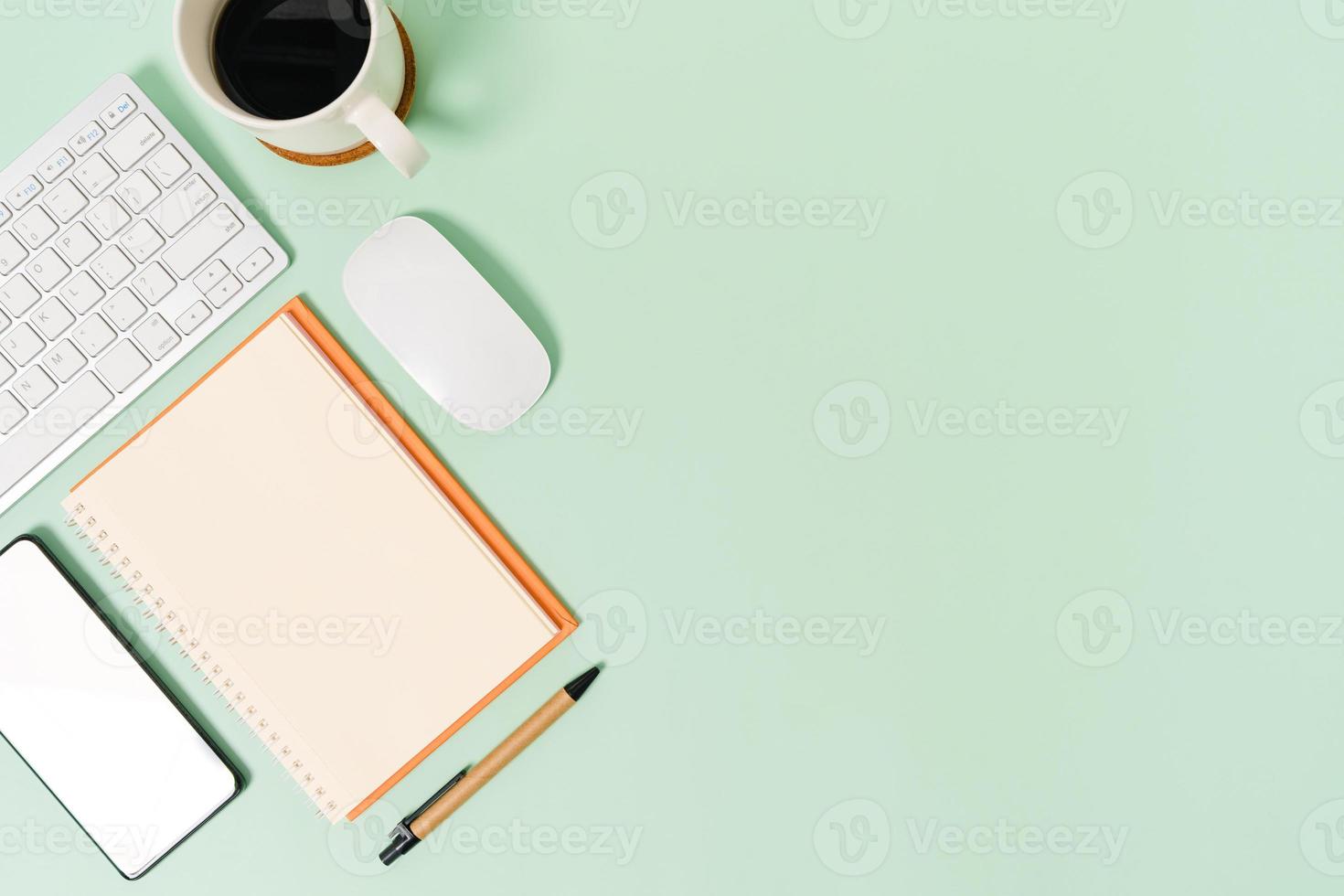 Minimal work space - Creative flat lay photo of workspace desk. Top view office desk with keyboard, mouse and notebook on pastel green color background. Top view with copy space, flat lay photography.