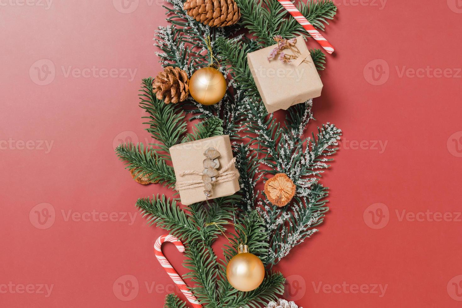 Minimal creative flat lay of christmas traditional composition and new year holiday season. Top view winter christmas decorations on red background with blank space for text. Copy space photography. photo
