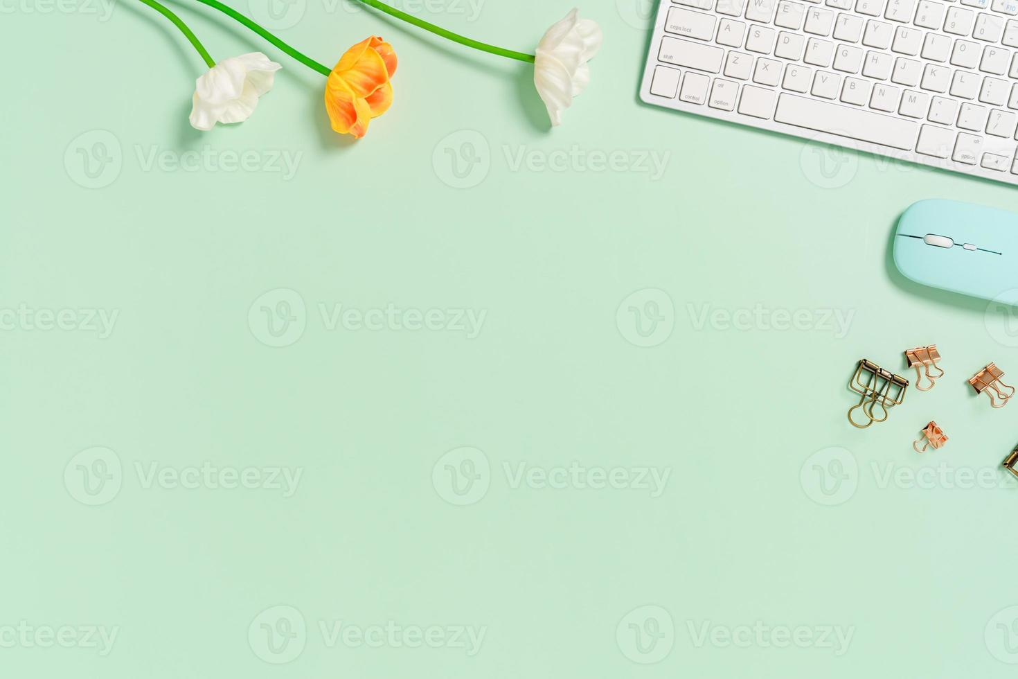 Minimal work space - Creative flat lay photo of workspace desk. Top view office desk with keyboard and mouse on pastel green color background. Top view with copy space, flat lay photography.