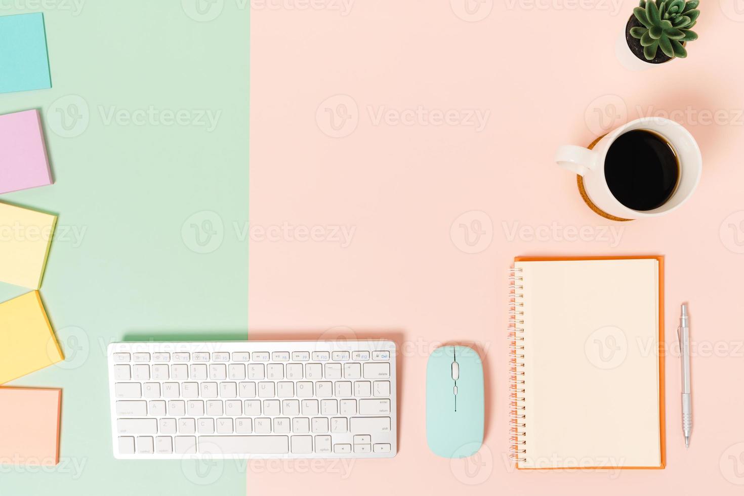 Creative flat lay photo of workspace desk. Top view office desk with keyboard, mouse and open mockup black notebook on pastel green pink color background. Top view mock up with copy space photography.