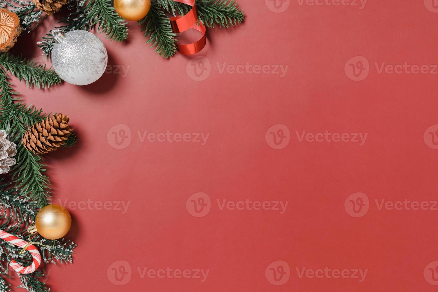 Minimal creative flat lay of christmas traditional composition and new year holiday season. Top view winter christmas decorations on red background with blank space for text. Copy space photography. photo