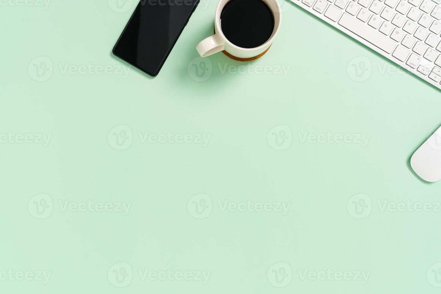 Minimal work space - Creative flat lay photo of workspace desk. Top view office desk with keyboard and mouse on pastel green color background. Top view with copy space, flat lay photography.