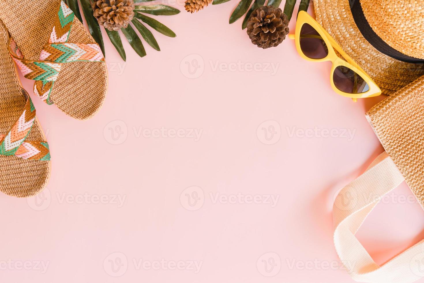 Creative flat lay photo of travel vacation spring or summer tropical fashion. Top view beach accessories on pastel pink color background with blank space for text. Top view copy space photography.