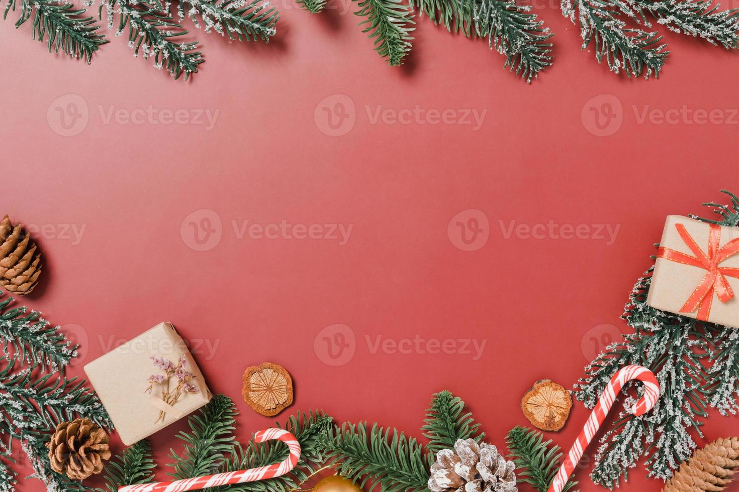 Minimal creative flat lay of christmas traditional composition and new year holiday season. Top view winter christmas decorations on red background with blank space for text. Copy space photography. photo