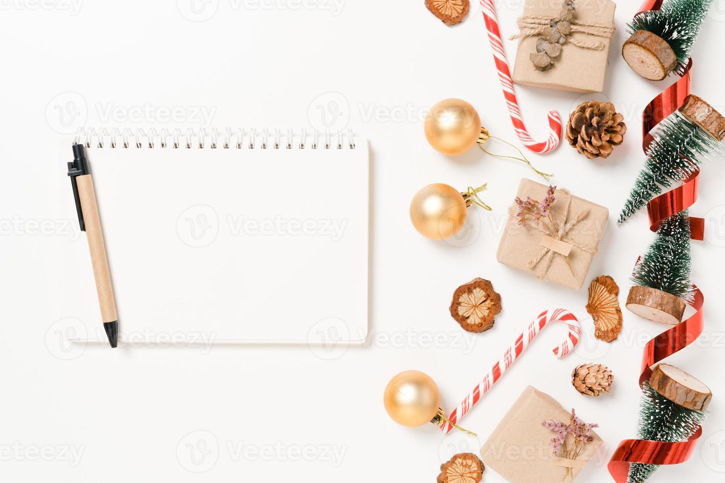 Minimal creative flat lay of winter christmas traditional composition and new year holiday season. Top view open mockup black notebook for text on white background. Mock up and copy space photography. photo