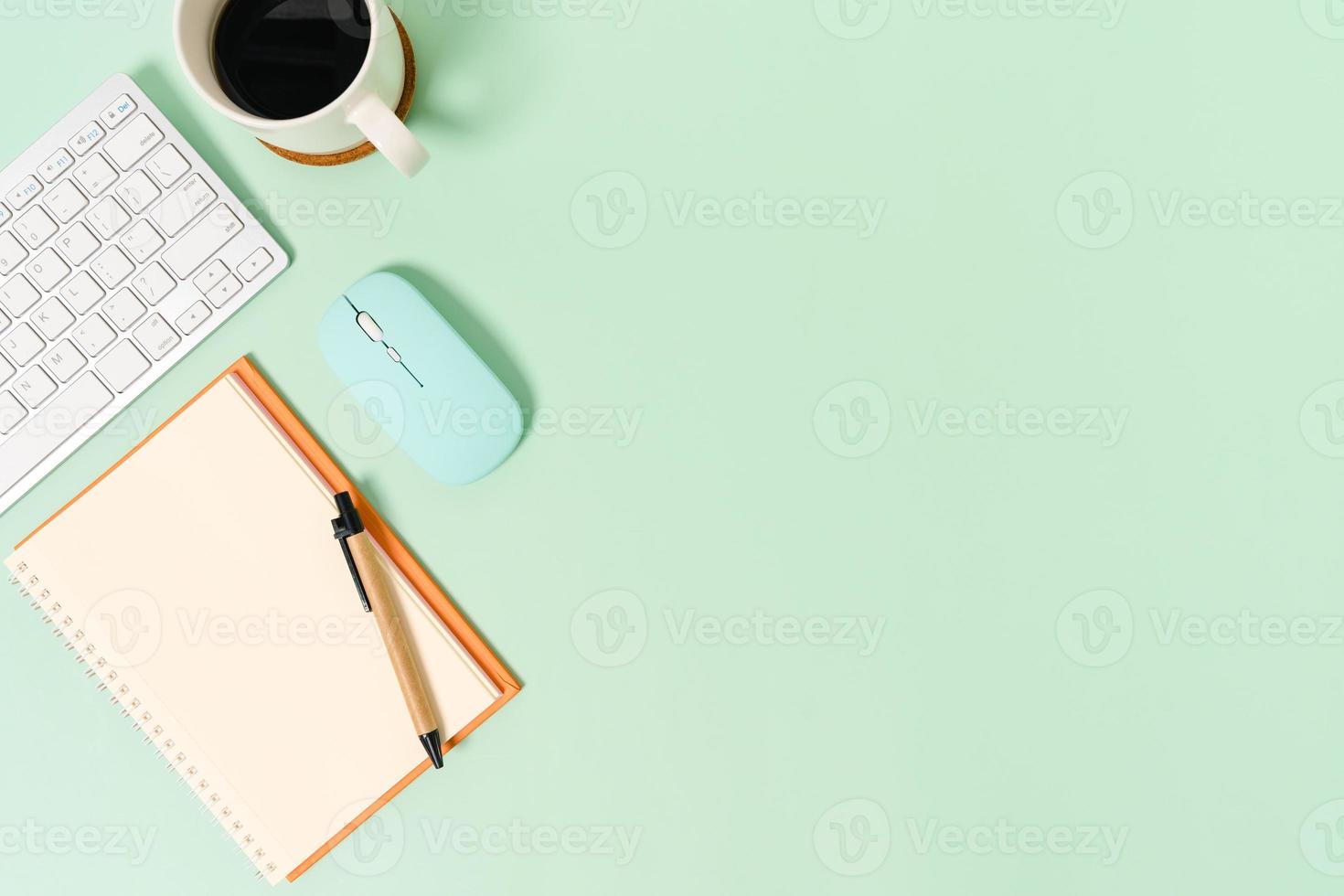Creative flat lay photo of workspace desk. Top view office desk with keyboard, mouse and open mockup black notebook on pastel green color background. Top view mock up with copy space photography.