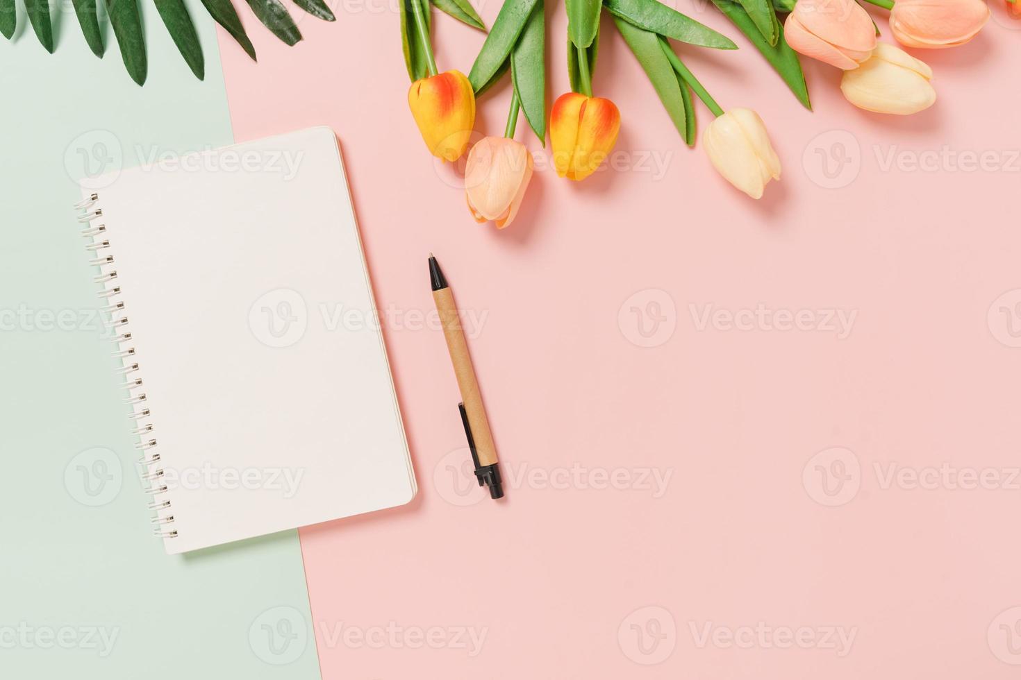 Creative flat lay of travel vacation spring or summer tropical fashion. Top view beach accessories open mockup black notebook for text on pastel background. Top view mock up copy space photography. photo