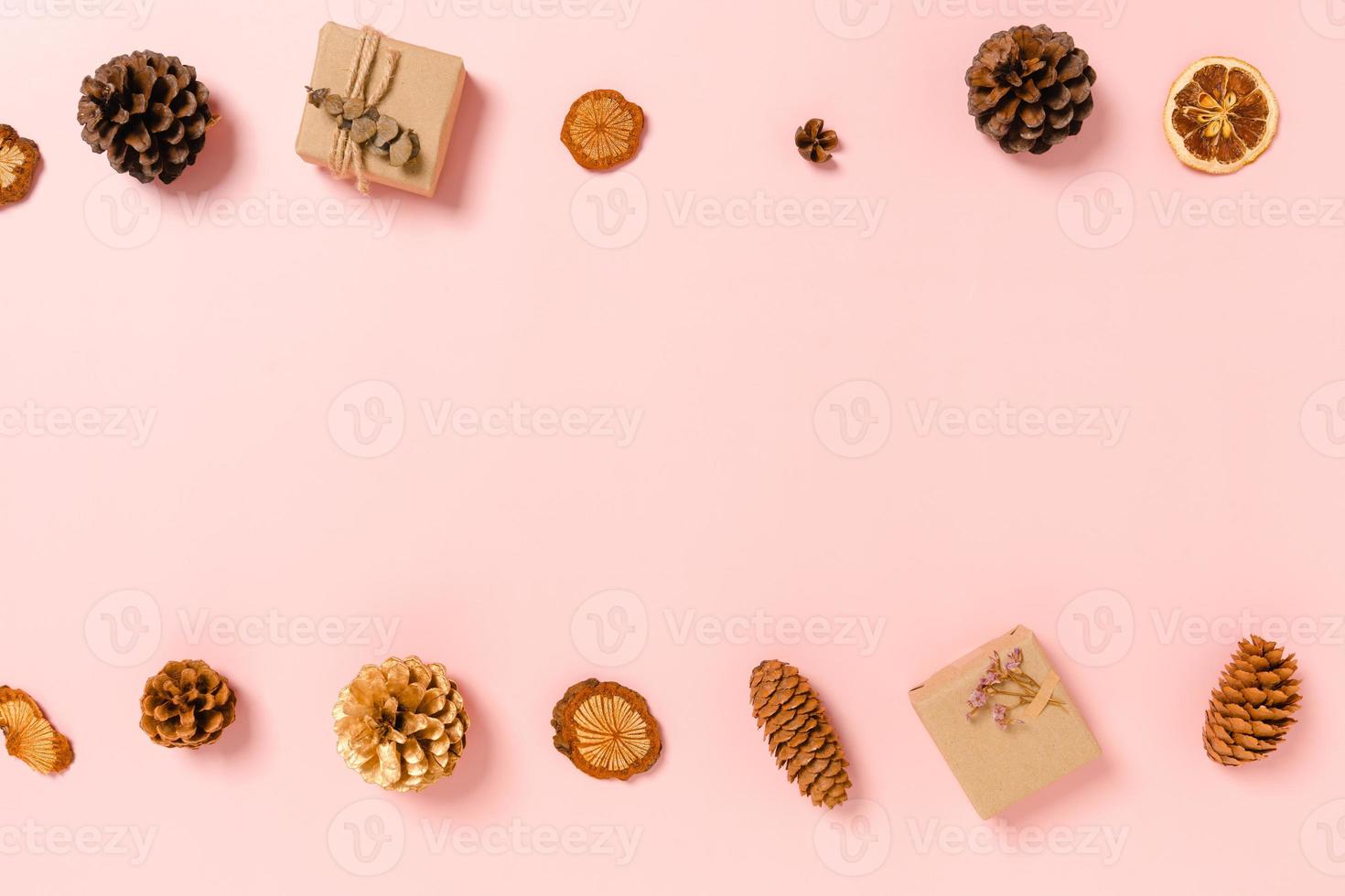 Minimal creative flat lay of christmas traditional composition and new year holiday season. Top view winter christmas decorations on pink background with blank space for text. Copy space photography. photo