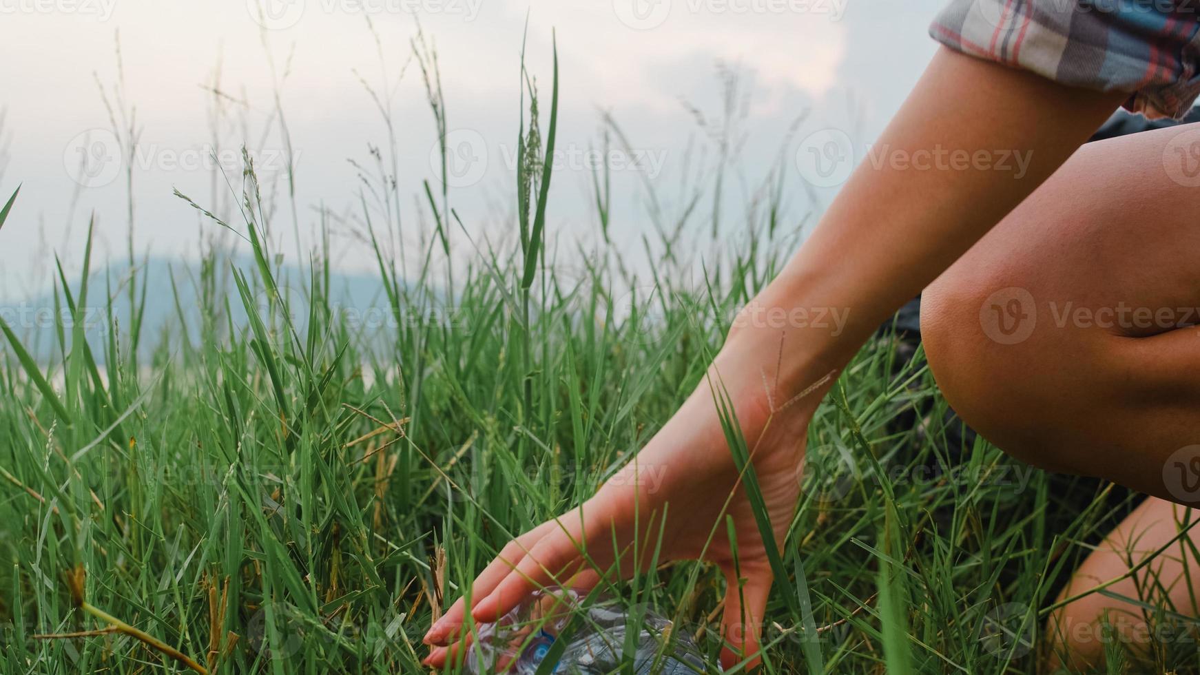 felices jóvenes activistas asiáticos que recogen desechos plásticos en el bosque. Las voluntarias coreanas ayudan a mantener la naturaleza limpia y a recoger basura. concepto sobre los problemas de contaminación de la conservación del medio ambiente. foto