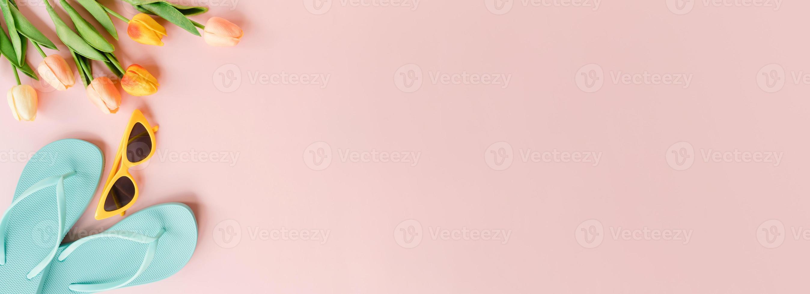 Creative flat lay of travel vacation spring or summer tropical fashion. Top view beach accessories on pastel pink color background. Panoramic banner with copy space for text and Advertising area. photo