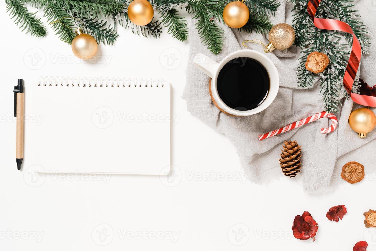 Minimal creative flat lay of winter christmas traditional composition and new year holiday season. Top view open mockup black notebook for text on white background. Mock up and copy space photography. photo