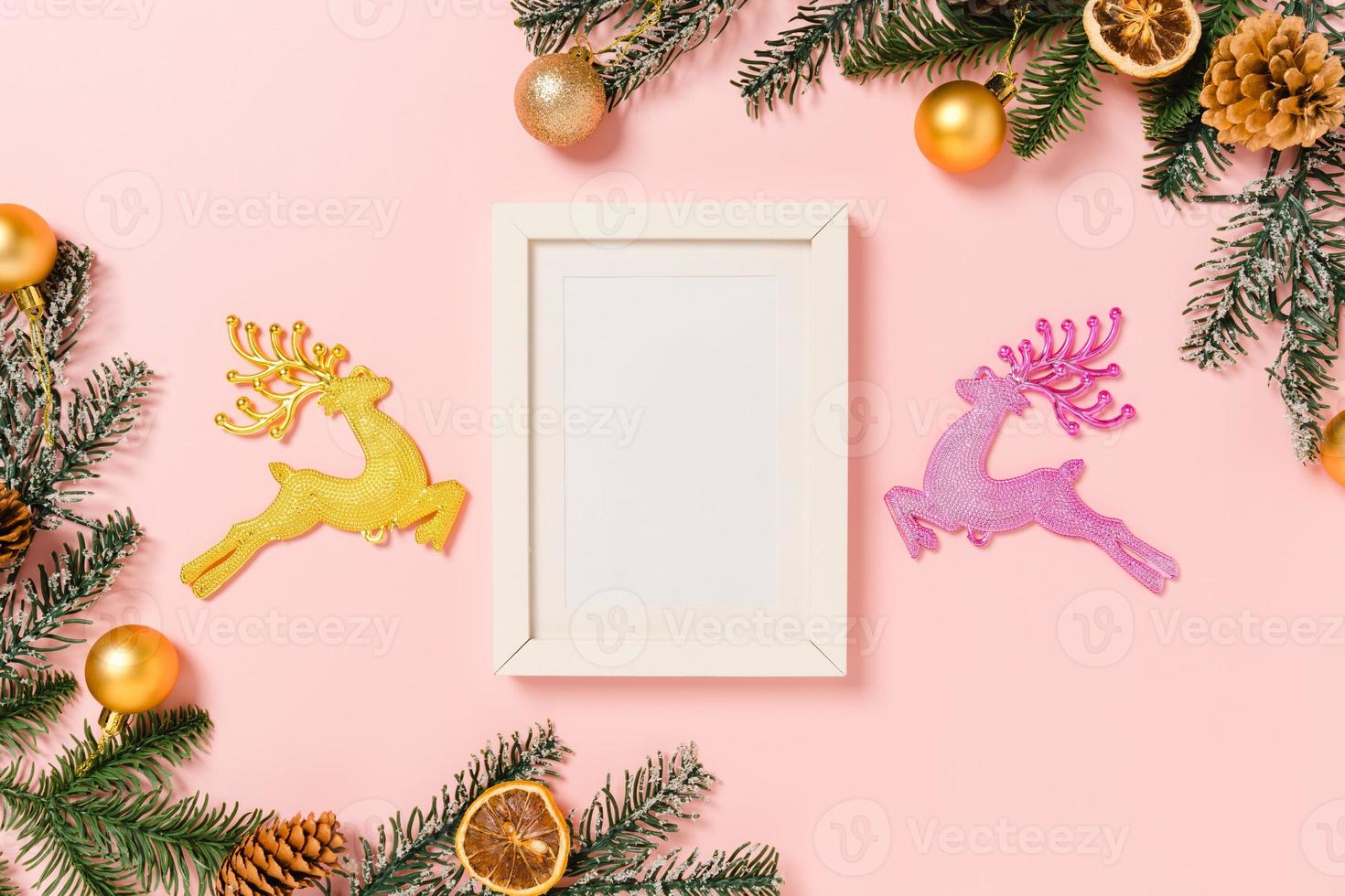 Minimal creative flat lay of winter christmas traditional composition and new year holiday season. Top view mockup black picture frames for text on pink background. Mock up and copy space photography. photo