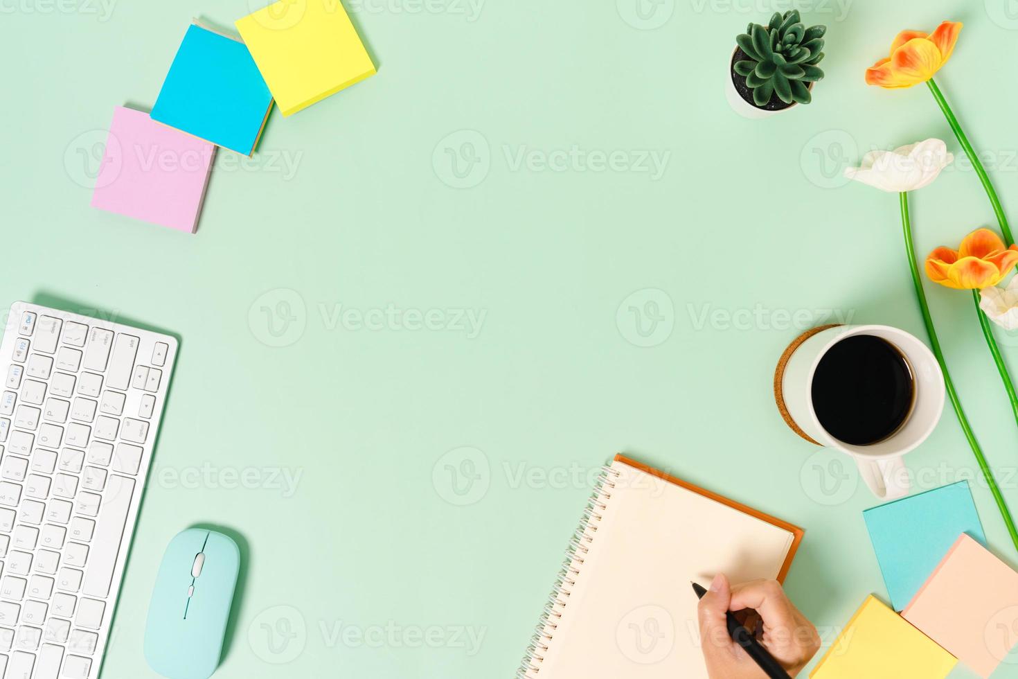 Creative flat lay photo of workspace desk. Top view office desk with keyboard, mouse and open mockup black notebook on pastel green color background. Top view mock up with copy space photography.