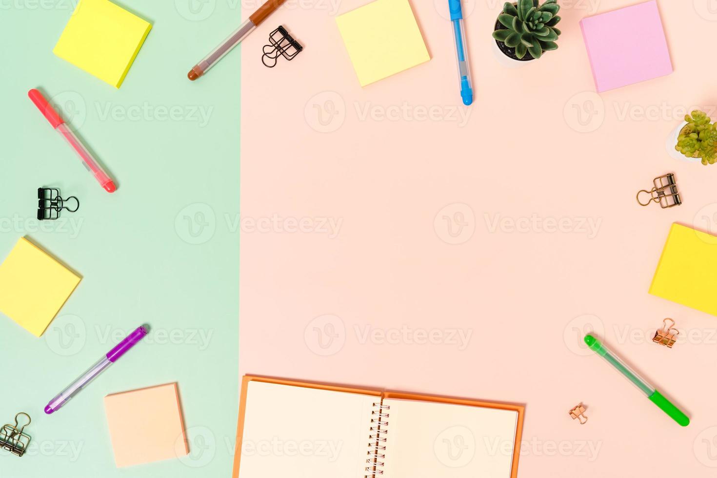 Foto creativa plana del escritorio del espacio de trabajo. escritorio de oficina de vista superior con teclado, mouse y cuaderno negro de maqueta abierta sobre fondo de color rosa verde pastel. vista superior maqueta con fotografía de espacio de copia.