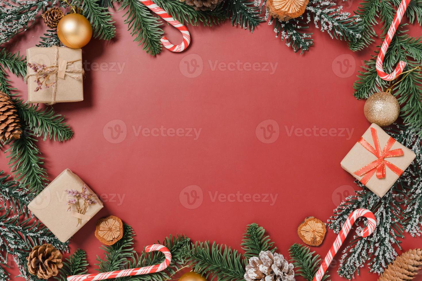 Minimal creative flat lay of christmas traditional composition and new year holiday season. Top view winter christmas decorations on red background with blank space for text. Copy space photography. photo