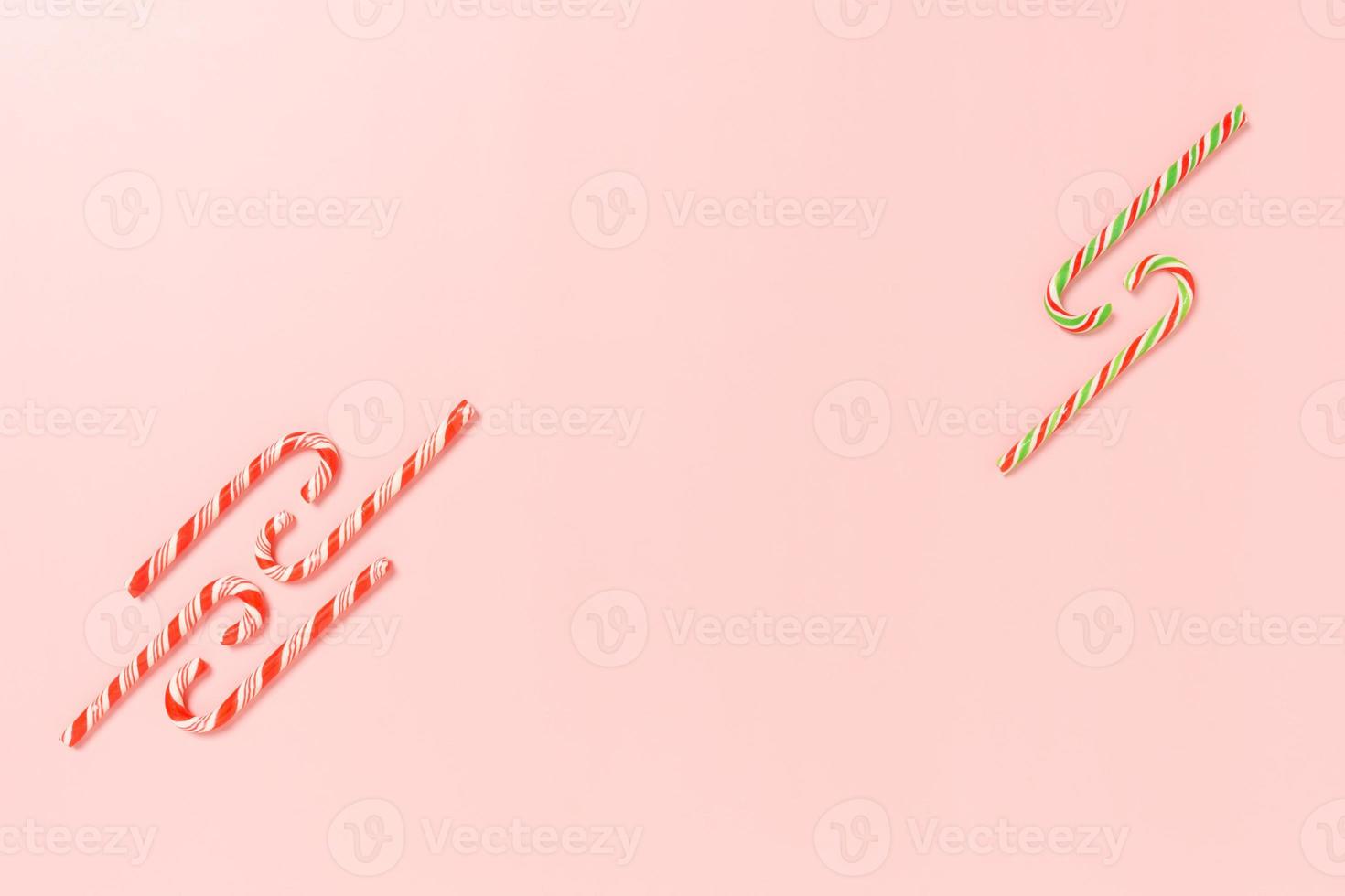 Minimal creative flat lay of christmas traditional composition and new year holiday season. Top view winter christmas decorations on pink background with blank space for text. Copy space photography. photo