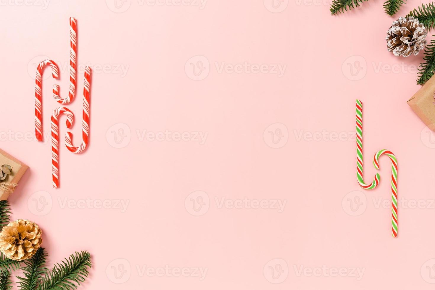 Minimal creative flat lay of christmas traditional composition and new year holiday season. Top view winter christmas decorations on pink background with blank space for text. Copy space photography. photo