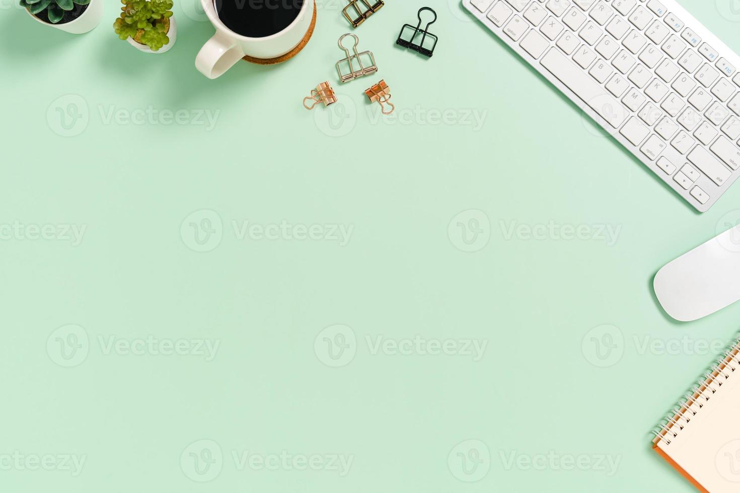 Minimal work space - Creative flat lay photo of workspace desk. Top view office desk with keyboard and mouse on pastel green color background. Top view with copy space, flat lay photography.
