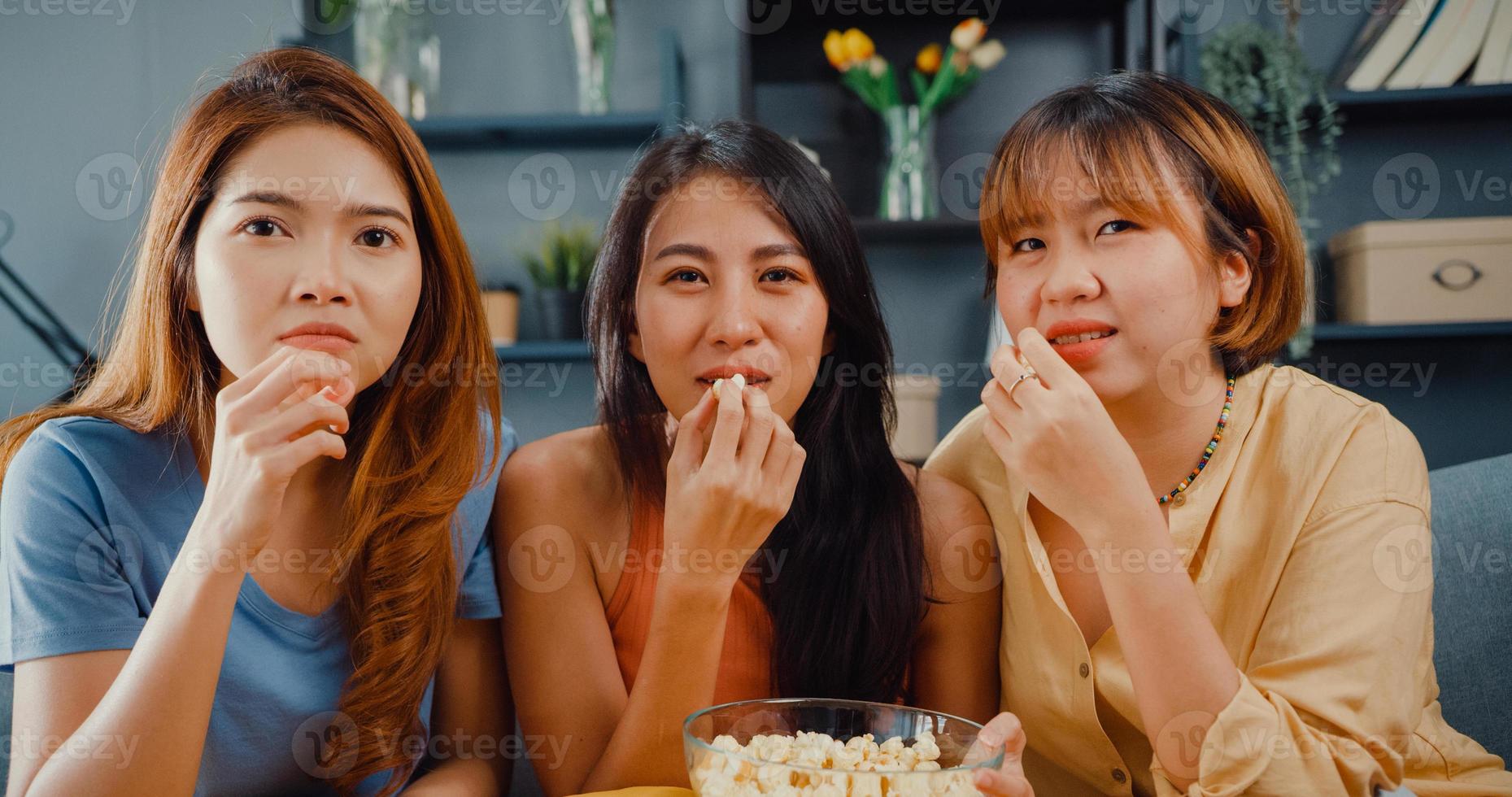 Attractive Asian lovely lady girl group positive glad cheerful with casual have fun and enjoy watch online movie entertainment on couch in living room at home. Lifestyle activity quarantine concept. photo
