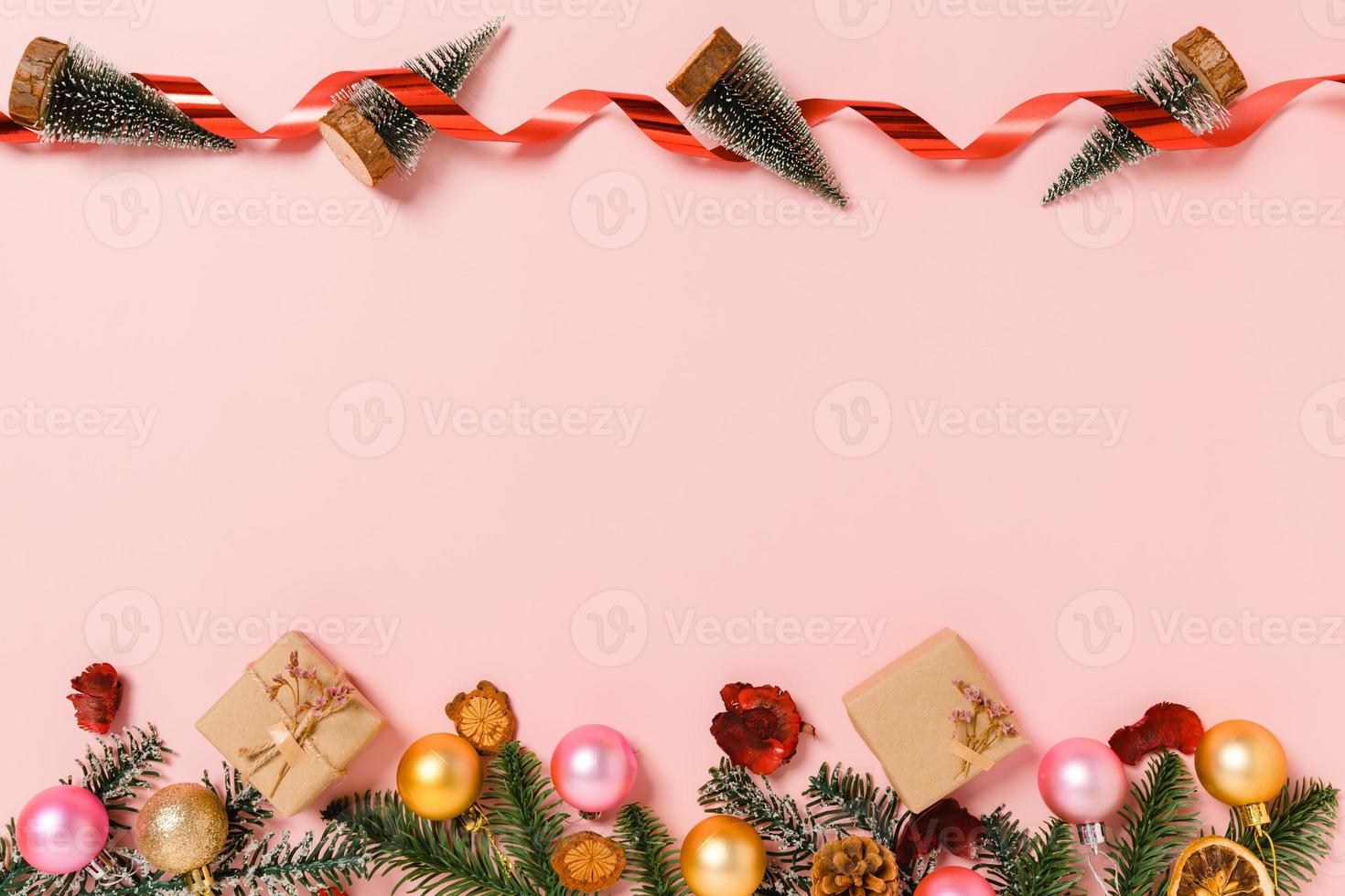 Minimal creative flat lay of christmas traditional composition and new year holiday season. Top view winter christmas decorations on pink background with blank space for text. Copy space photography. photo