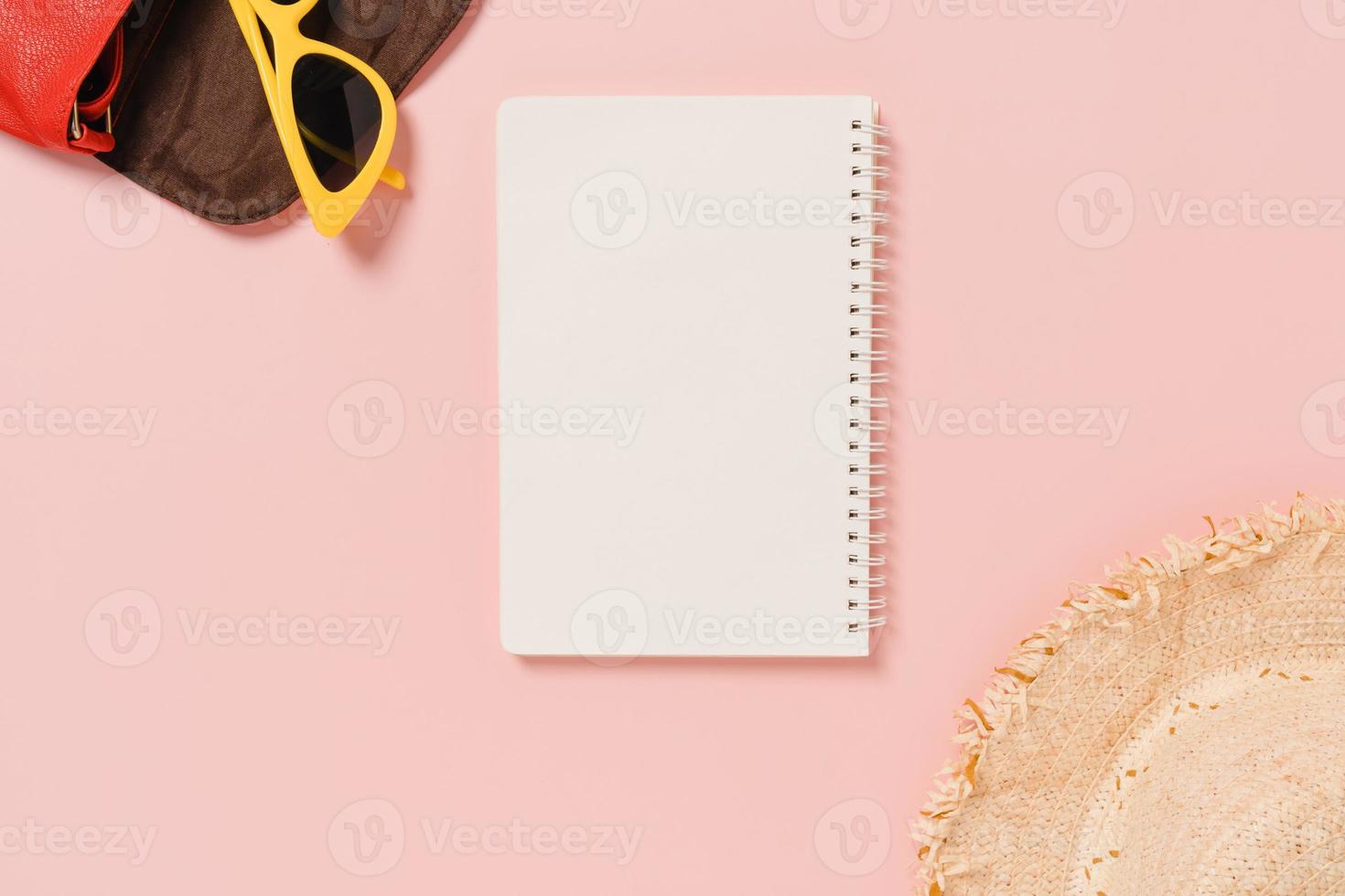 Creative flat lay of travel vacation spring or summer tropical fashion. Top view beach accessories open mockup black notebook for text on pastel background. Top view mock up copy space photography. photo