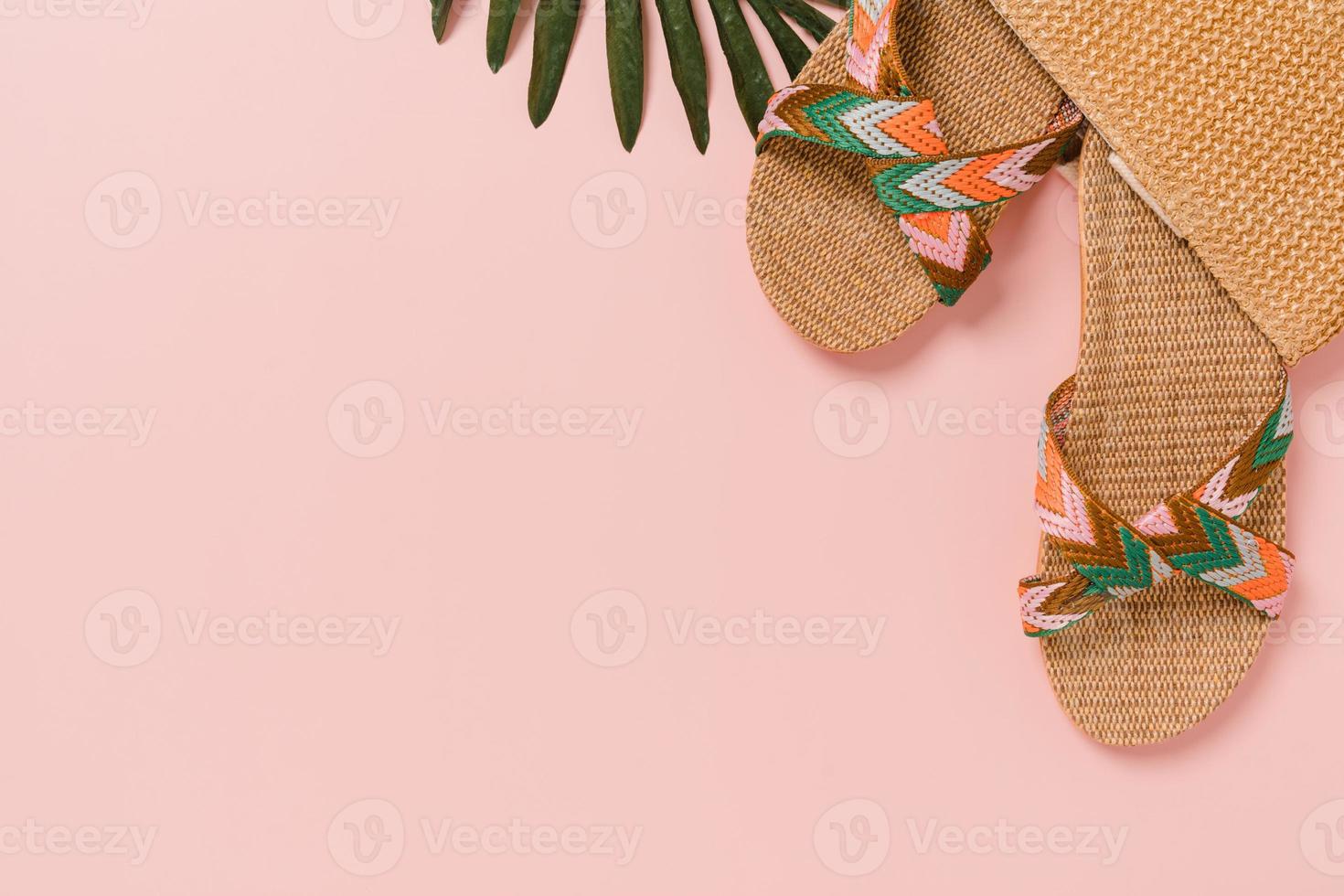 Creative flat lay photo of travel vacation spring or summer tropical fashion. Top view beach accessories on pastel pink color background with blank space for text. Top view copy space photography.