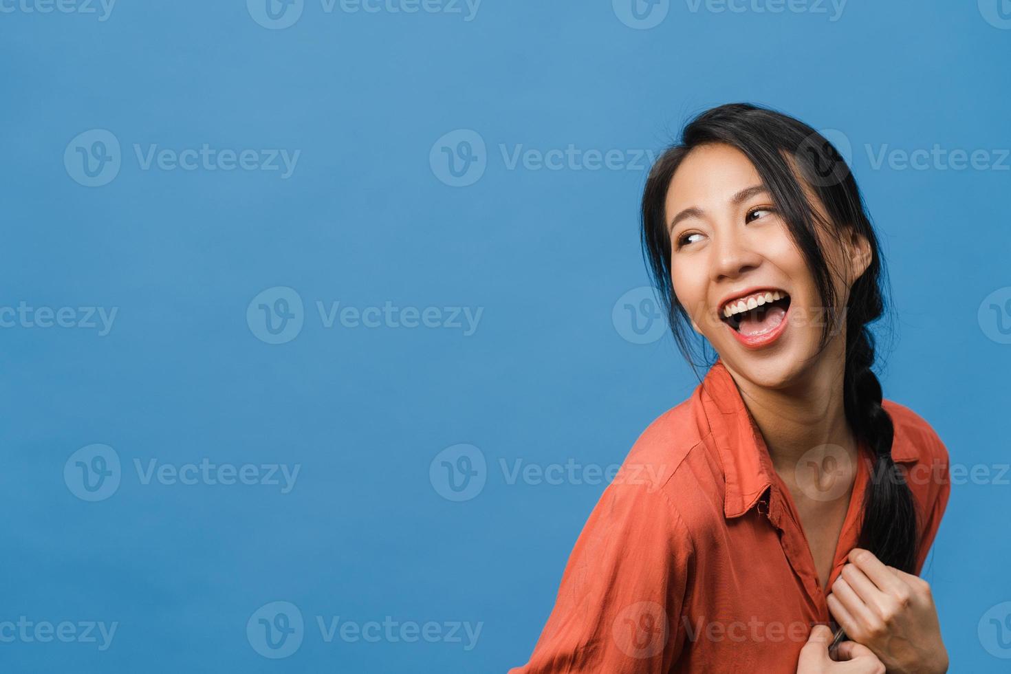 Portrait of young Asia lady with positive expression, smile broadly, dressed in casual clothing over blue background. Happy adorable glad woman rejoices success. Facial expression concept. photo