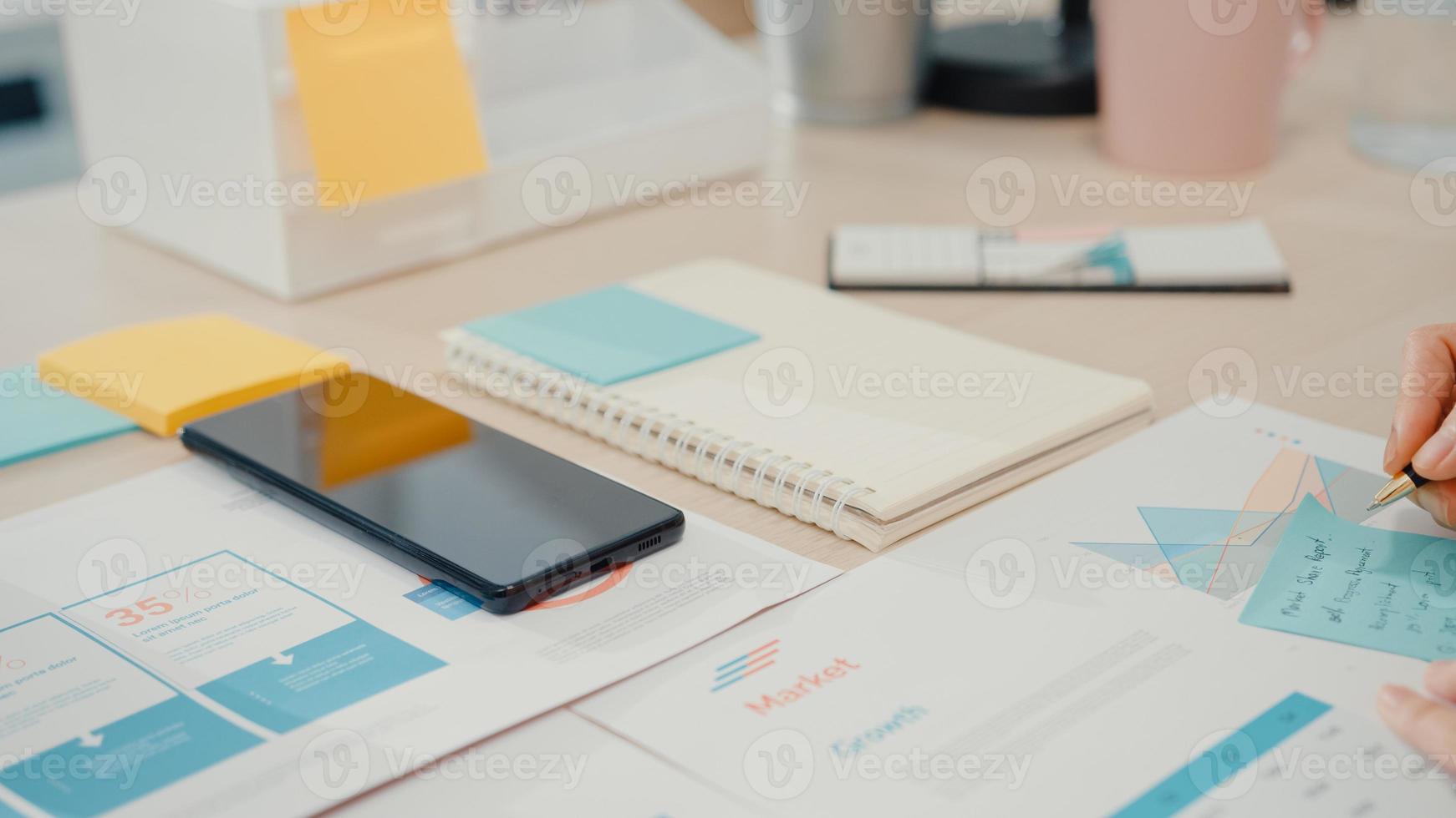 Young Asia businesswoman use smart phone with blank black screen mock up display for advertising text while smart working from home at living room. Chroma key technology, Marketing design concept. photo