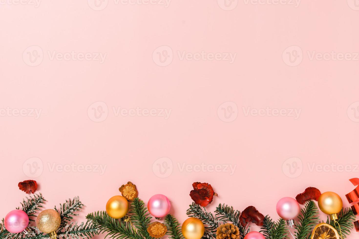 Minimal creative flat lay of christmas traditional composition and new year holiday season. Top view winter christmas decorations on pink background with blank space for text. Copy space photography. photo