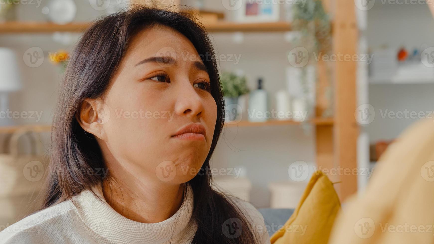 Sad young asian woman hug cuddle embracing with best friend in living room at home support each other with hard time with feel sick and bad, Relationship support concept. photo