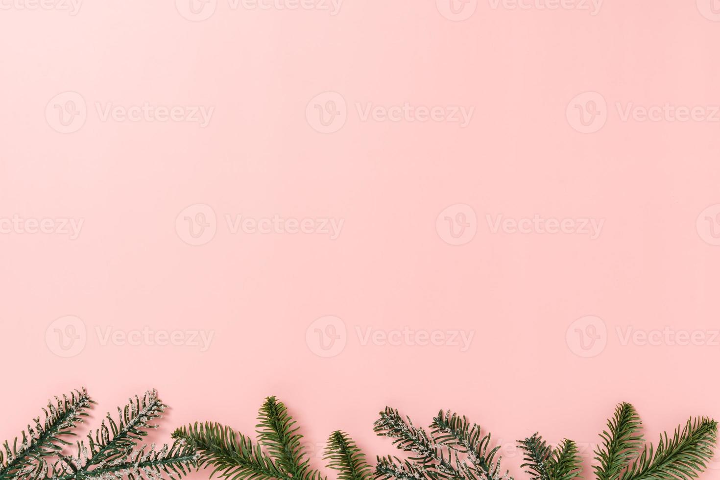 Minimal creative flat lay of christmas traditional composition and new year holiday season. Top view winter christmas decorations on pink background with blank space for text. Copy space photography. photo