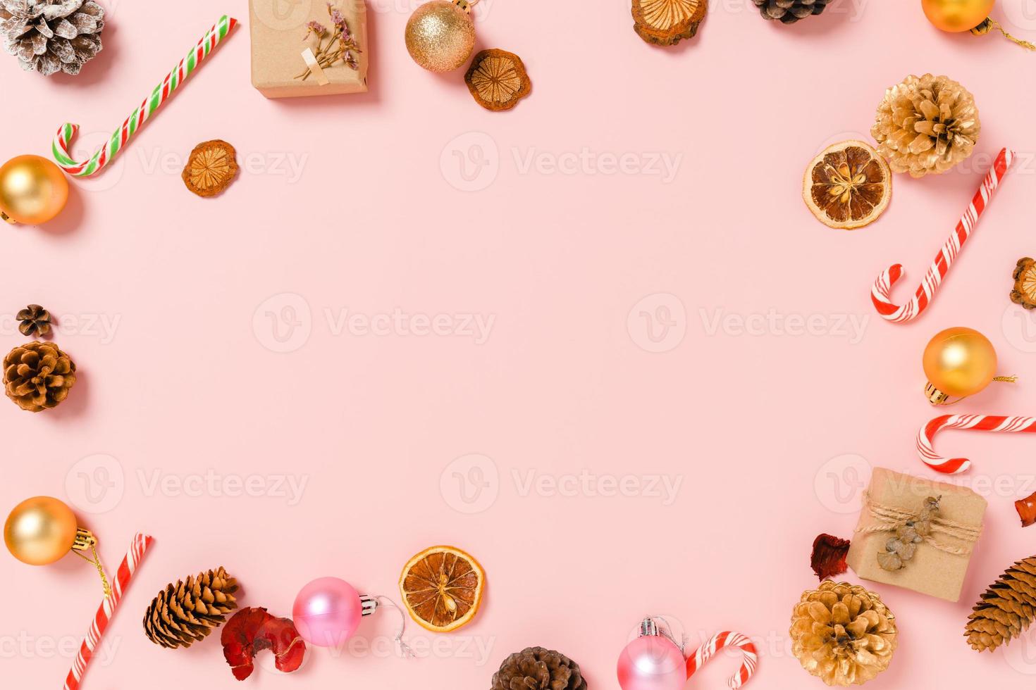 Minimal creative flat lay of christmas traditional composition and new year holiday season. Top view winter christmas decorations on pink background with blank space for text. Copy space photography. photo